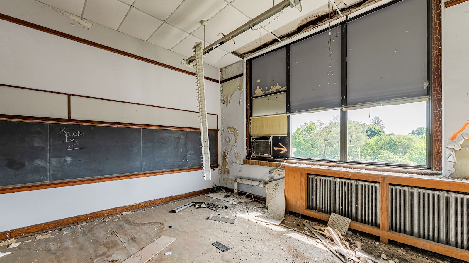Photo showing interior of unit prior to renovations. There is debris across the floor.